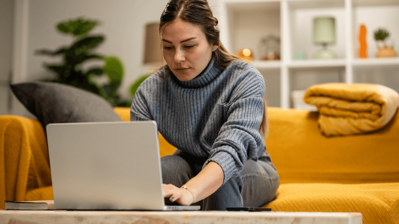 Woman researching can employers retaliate after an HR complaint on laptop at home